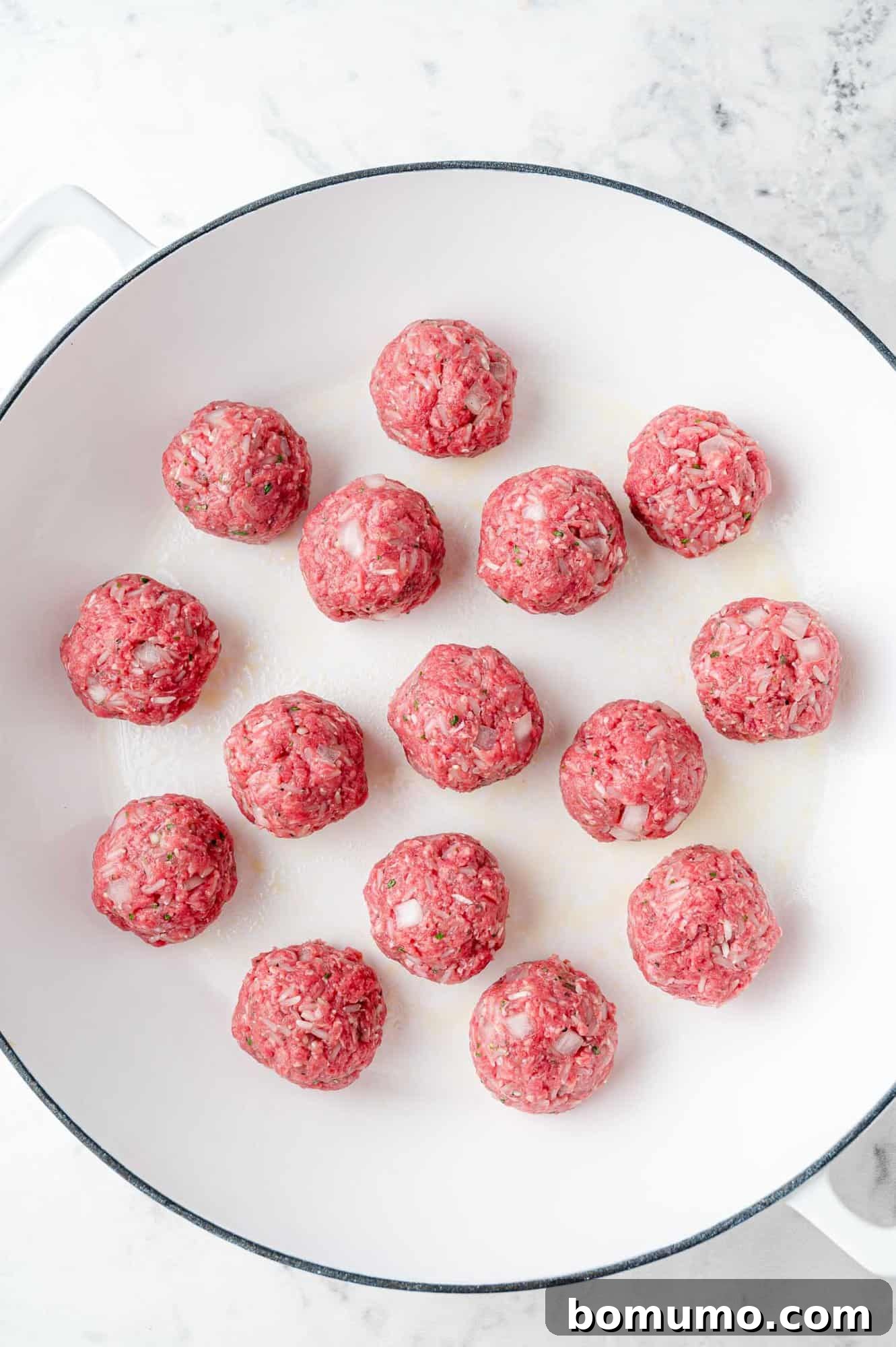 Rice-Studded Meatballs 7 Ingredients formed and placed in pan.