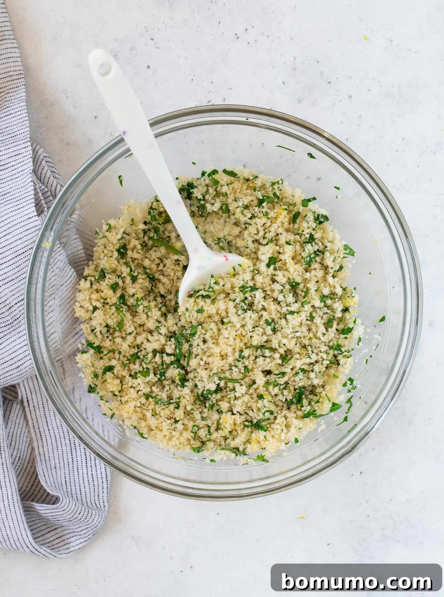 Creamy Asparagus Bake 15 Mixed breadcrumb topping in a bowl, with panko, parsley, and lemon zest evenly coated with butter.