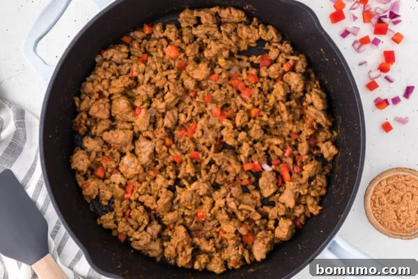 Sauteed ground turkey taco meat in a cast iron skillet.