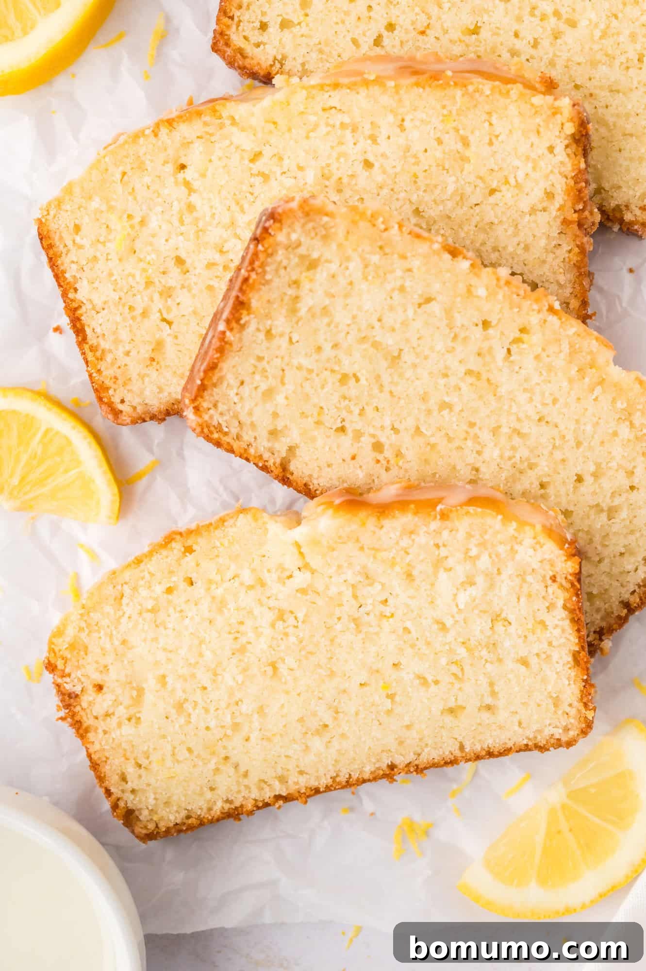 Lemon bread slices arranged on parchment paper.