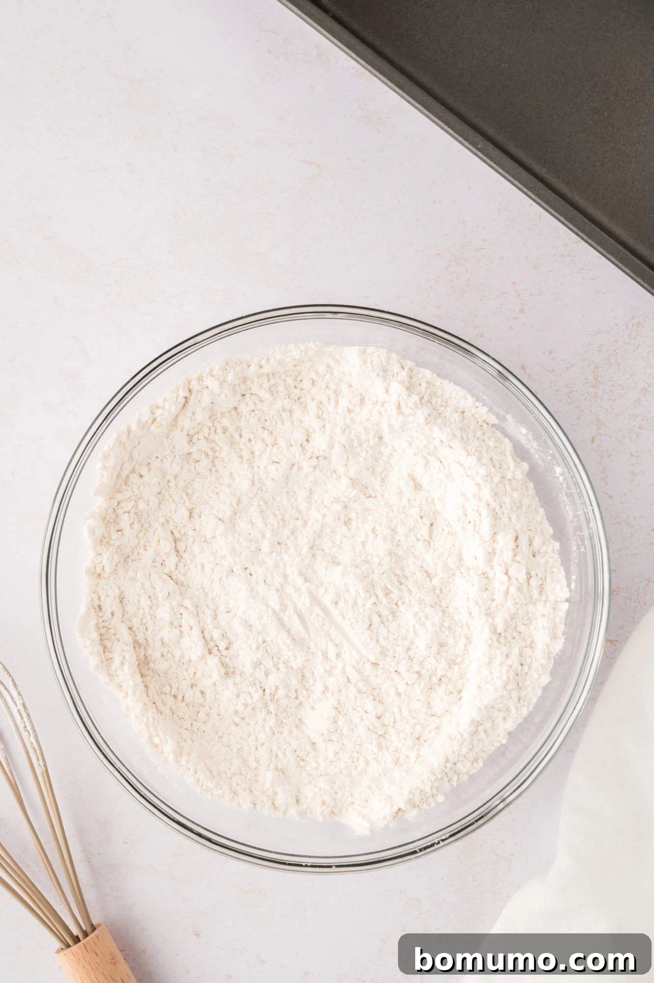 Dry ingredients in a clear glass bowl, mixed together.