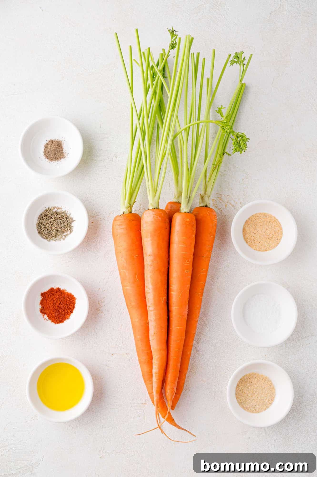 All the fresh ingredients laid out for making air fryer carrots, including vibrant carrots.