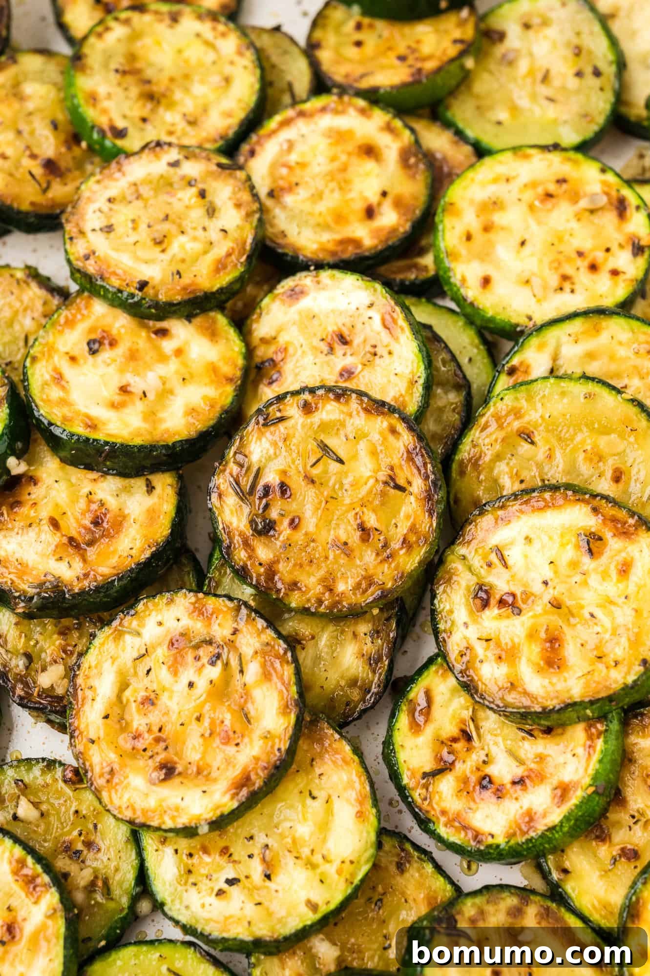Perfectly browned, tender-crisp sautéed zucchini slices ready to be served.