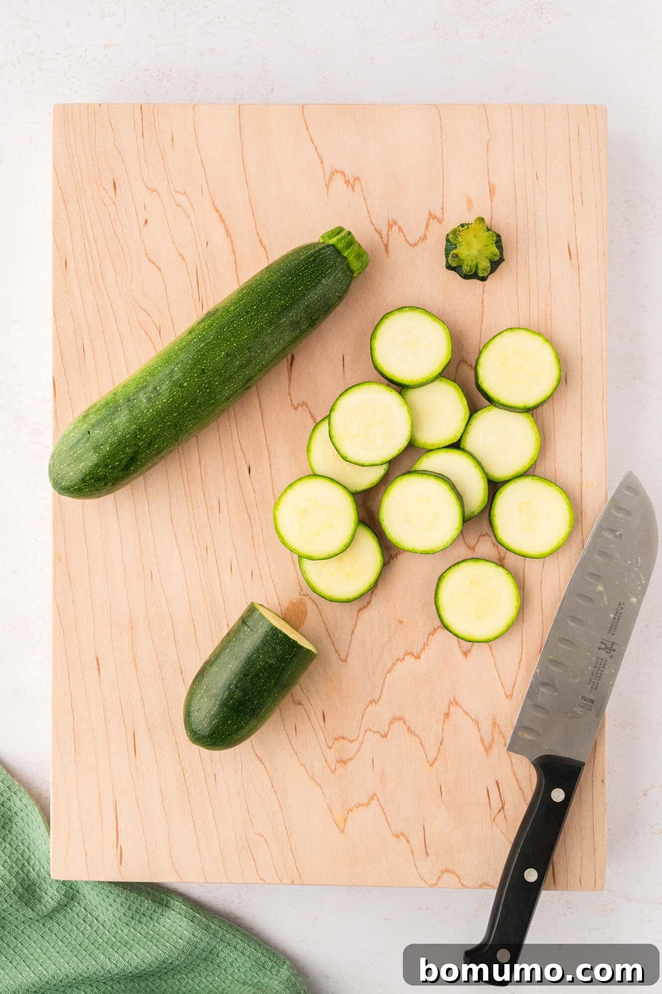 Zucchini, mostly sliced into uniform pieces, ready for cooking.