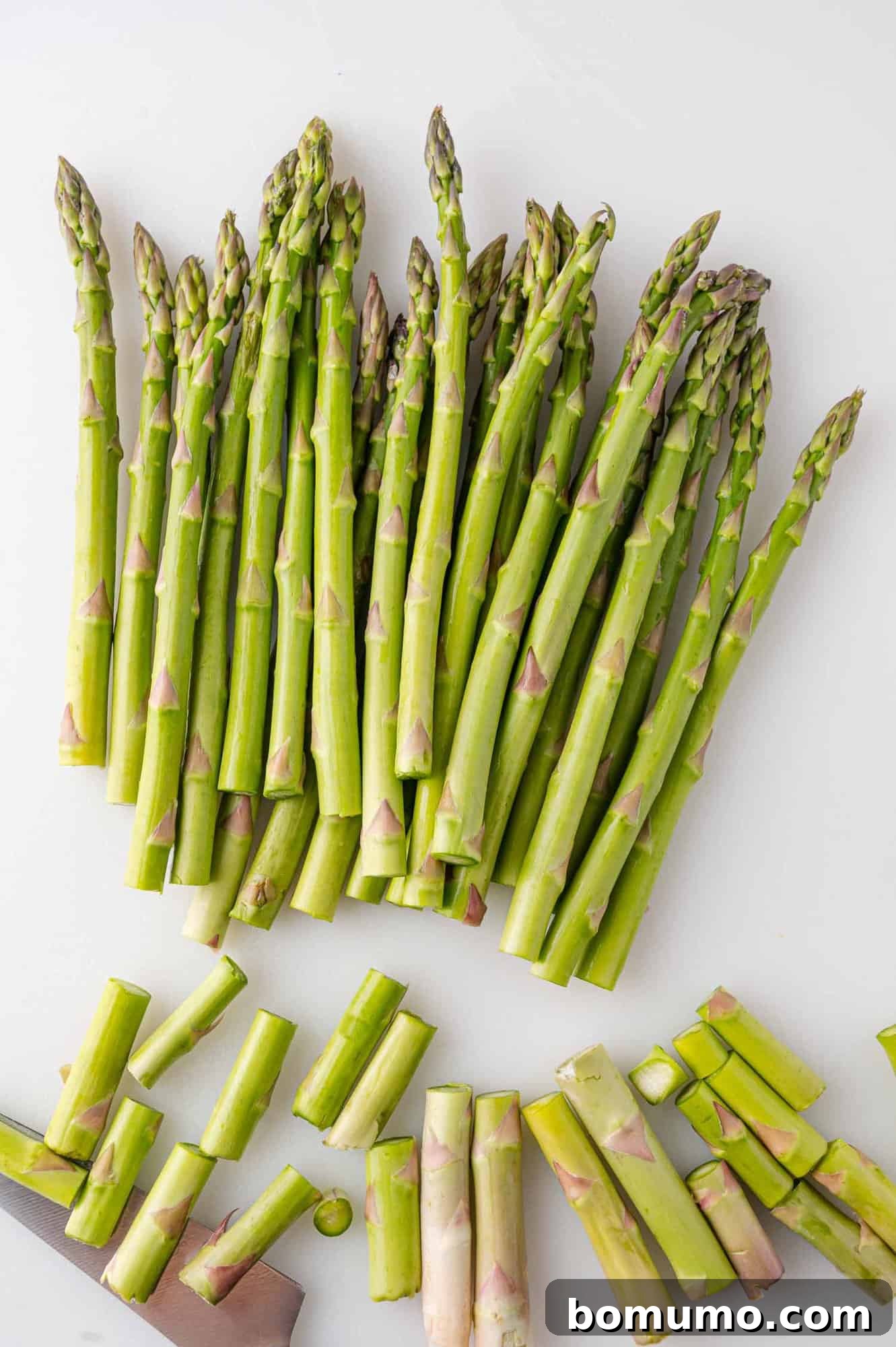 Fresh asparagus spears neatly trimmed, ready for sautéing.