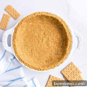 Homemade graham cracker crust in a white pie plate.