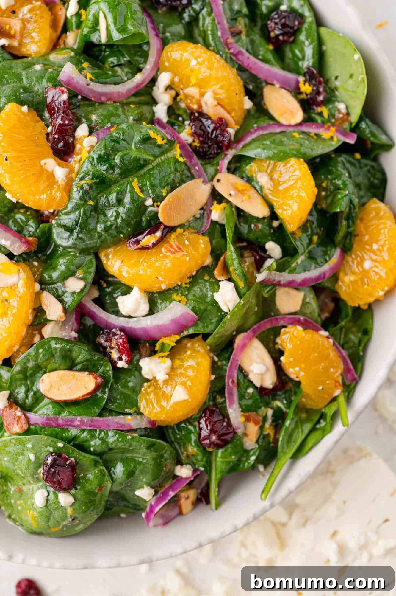 A large, inviting serving bowl filled to the brim with colorful mandarin orange salad, ready to be enjoyed at any gathering.