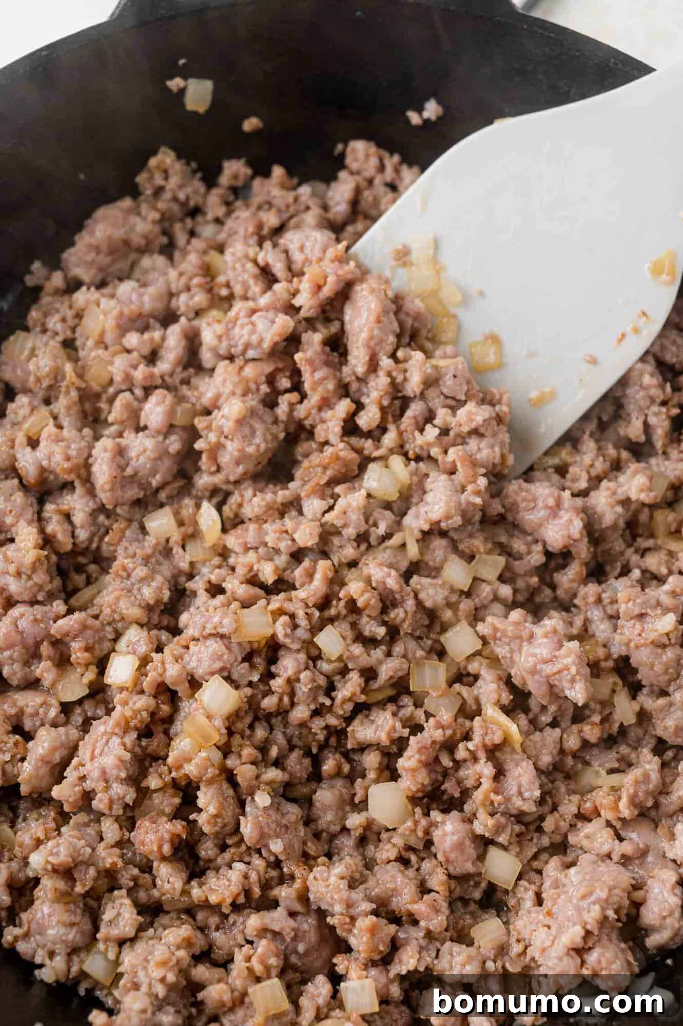 Sausage Cheese Bliss 5 Sausage and onions browned in a frying pan.