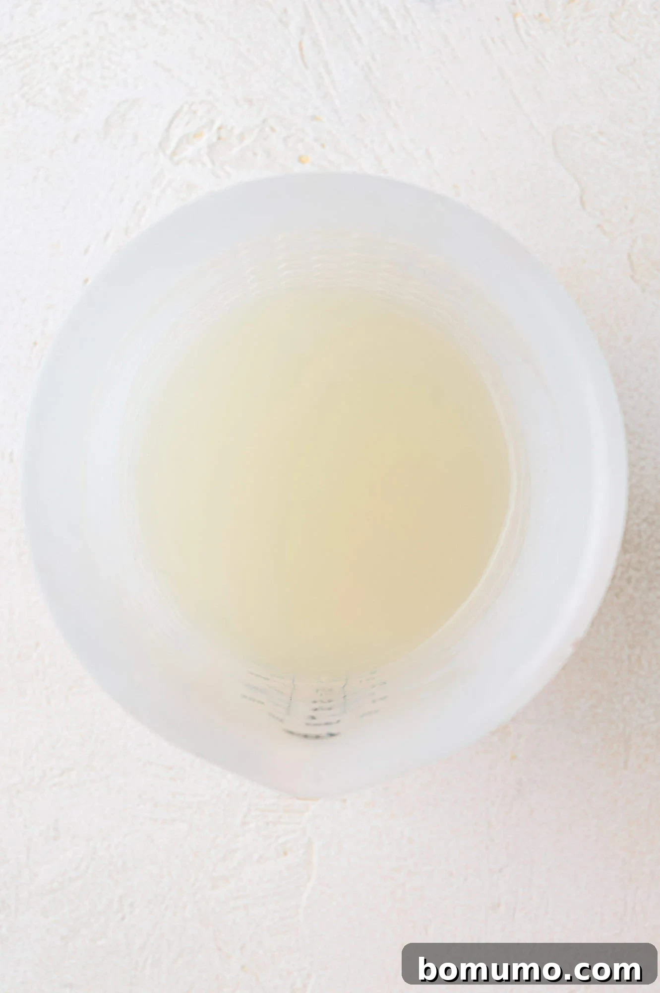 Pasta water reserved in a measuring cup.
