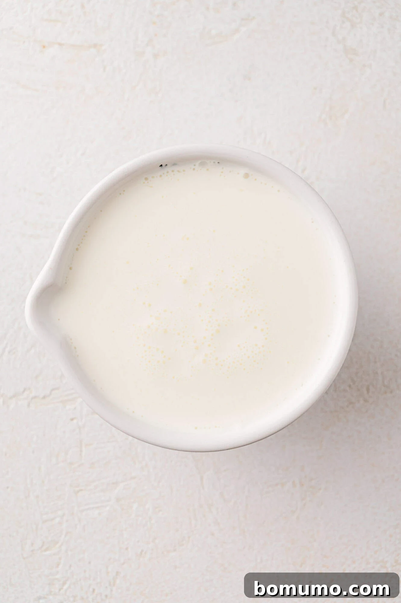 Cream in a measuring cup. 
