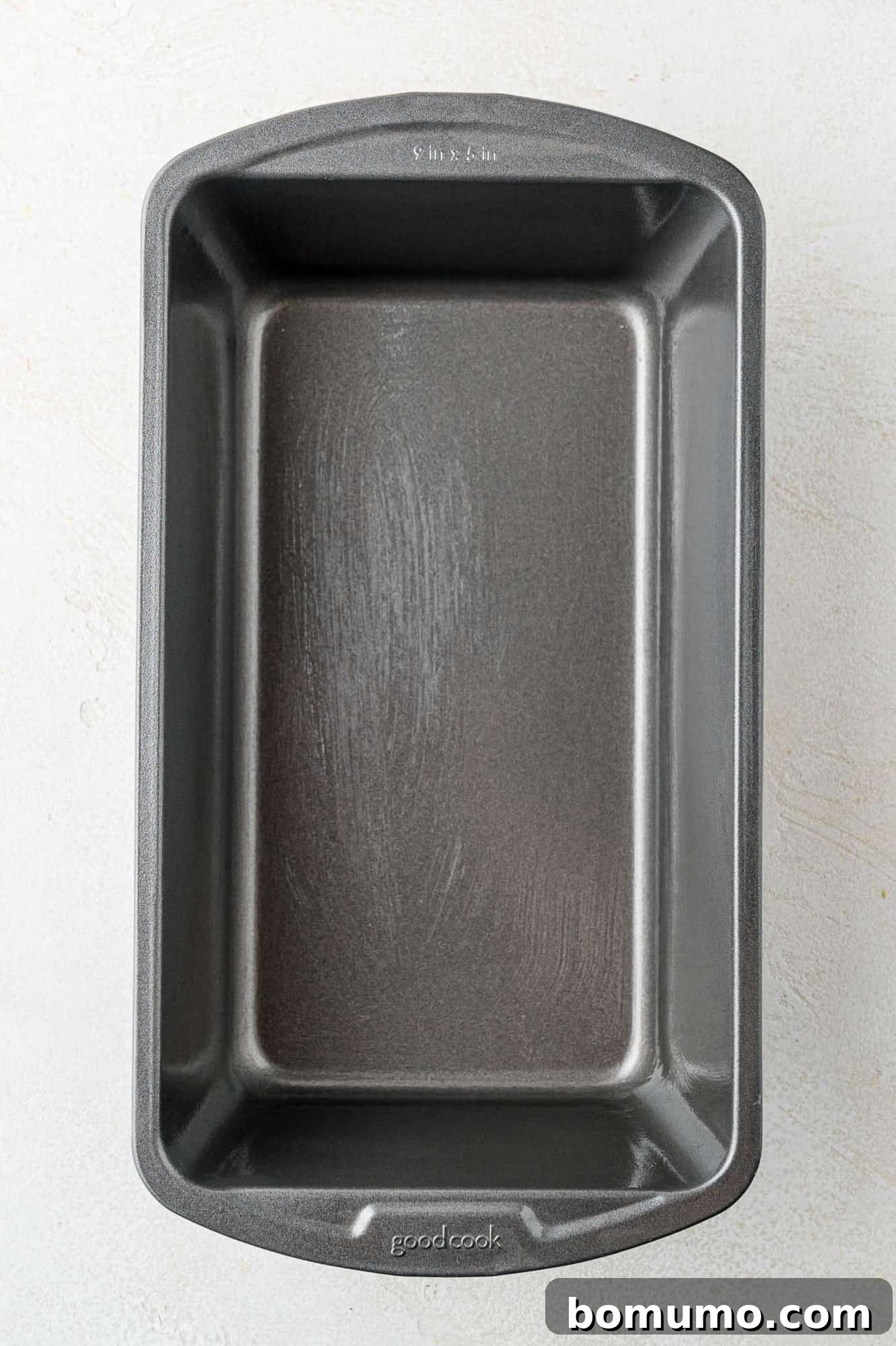 A 9x5 inch loaf pan, perfectly coated with nonstick cooking spray, ready for the batter.