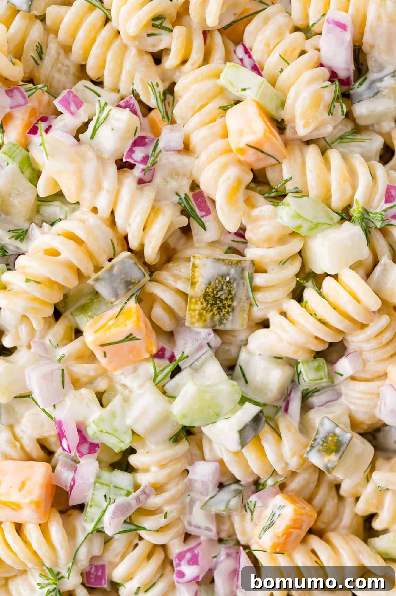 Dressing fully mixed into the dill pickle pasta salad.