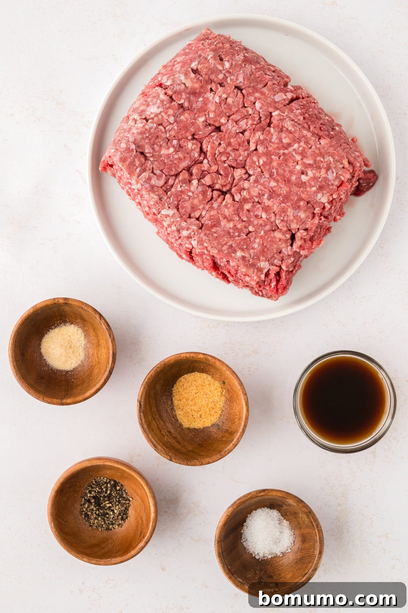 The Cali Dream Burger 4 A selection of fresh burger ingredients, including ground beef, spices, and cheese, neatly arranged for preparation.