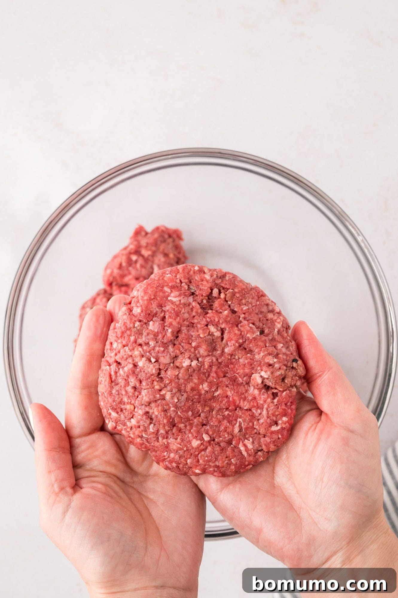 The Cali Dream Burger 8 A single portion of ground beef meticulously formed into a perfectly round patty.