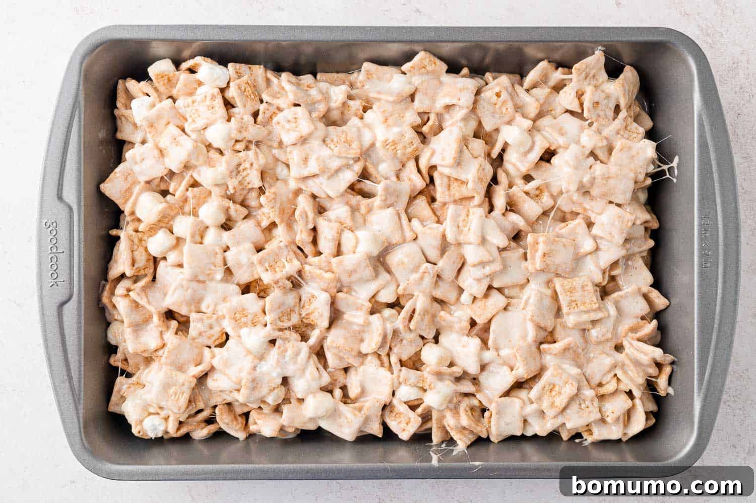 Cinnamon Crunch Bars 12 Cinnamon toast crunch bars in a pan, not yet cut.