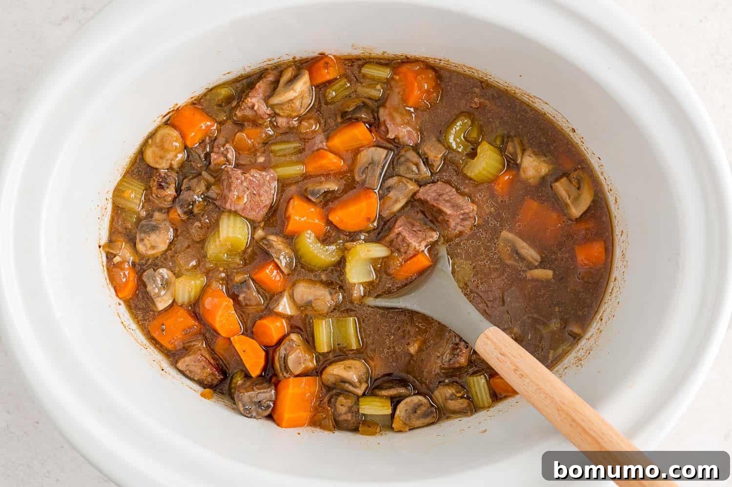 The finished Slow Cooker Beef Marsala Stew simmering gently in a crockpot, ready for the final touches.