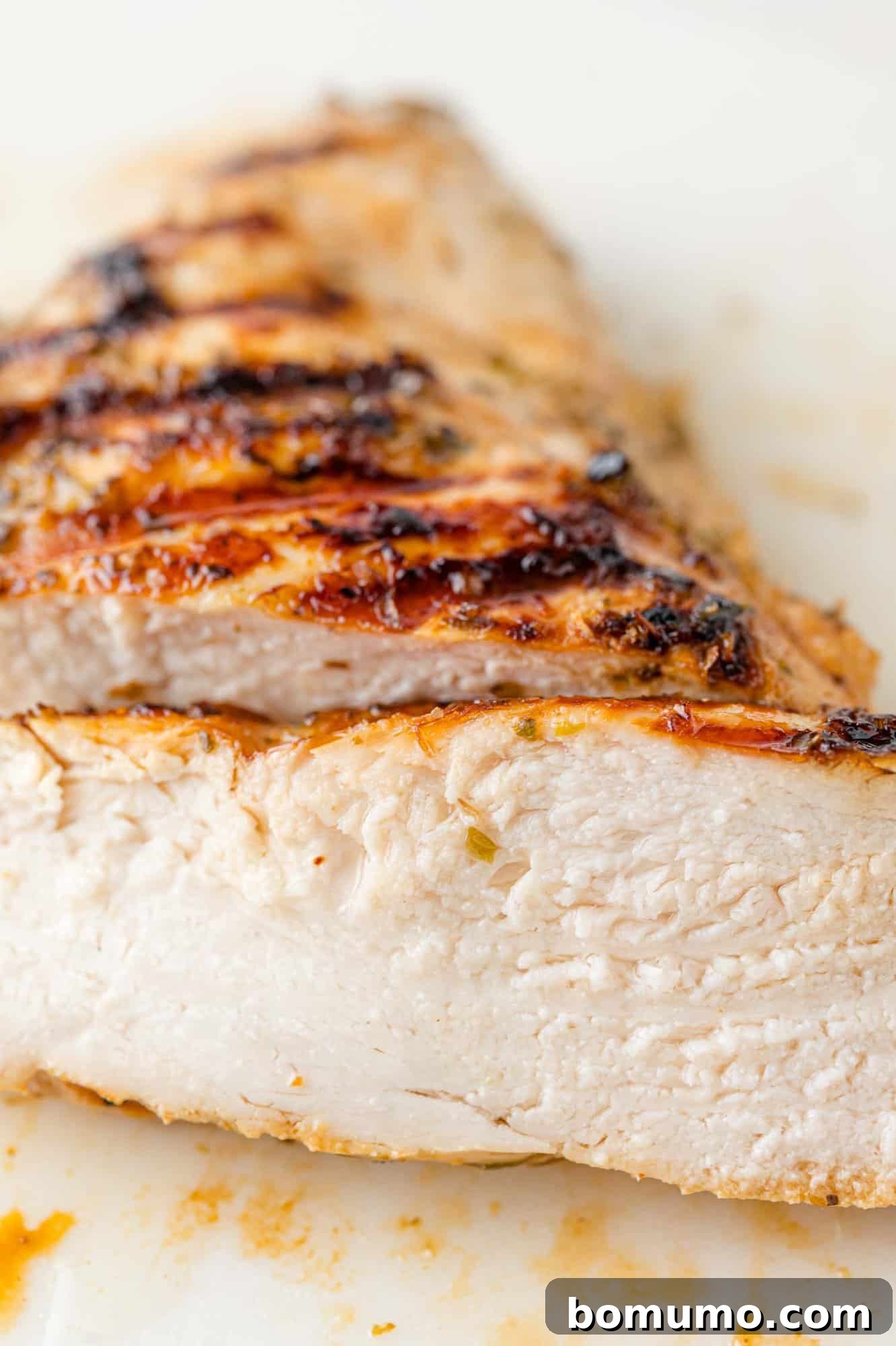 Perfectly grilled Greek chicken, cut into slices for serving.