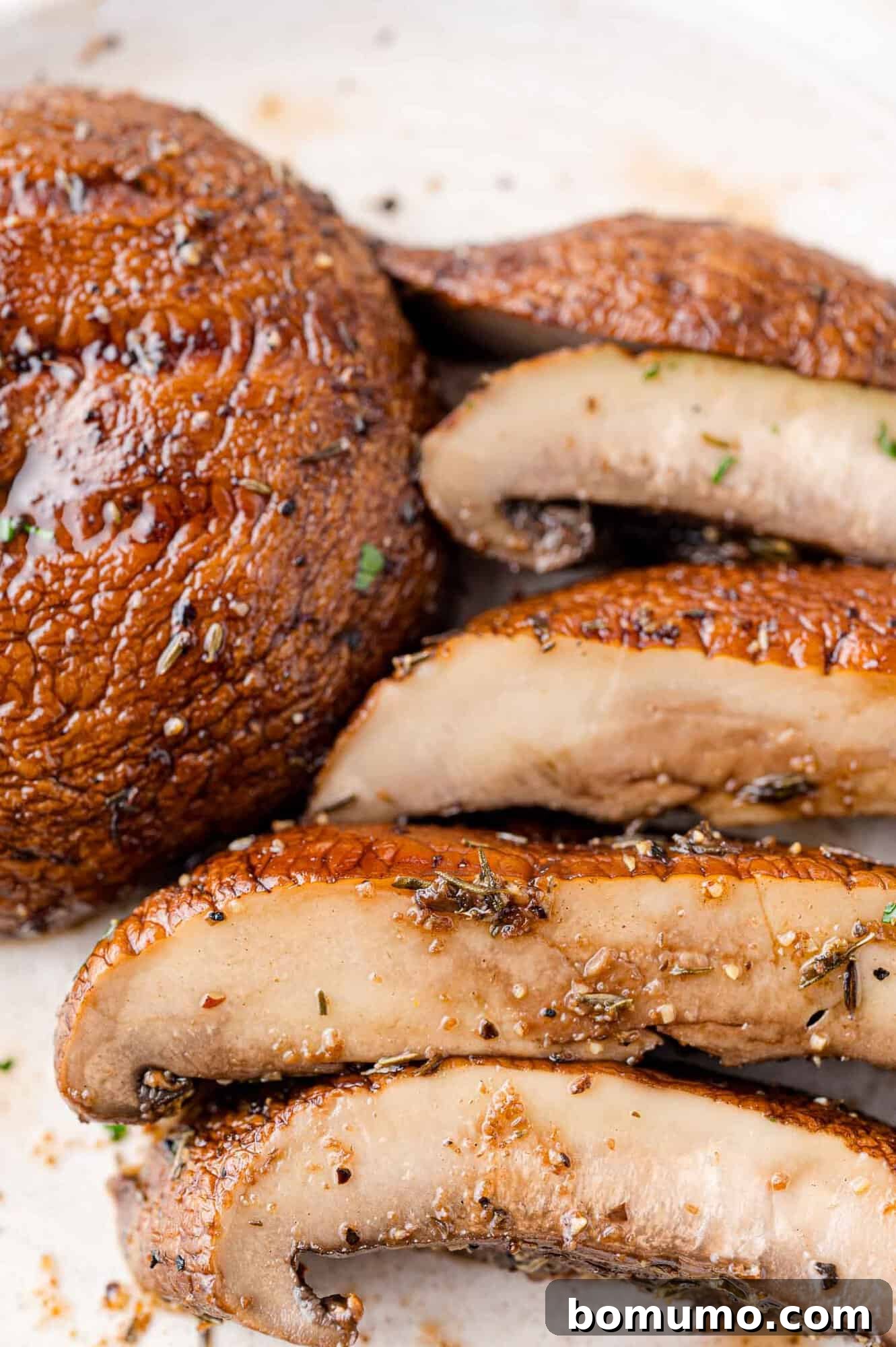 Grilled portobello mushroom, sliced for serving, revealing its tender interior.
