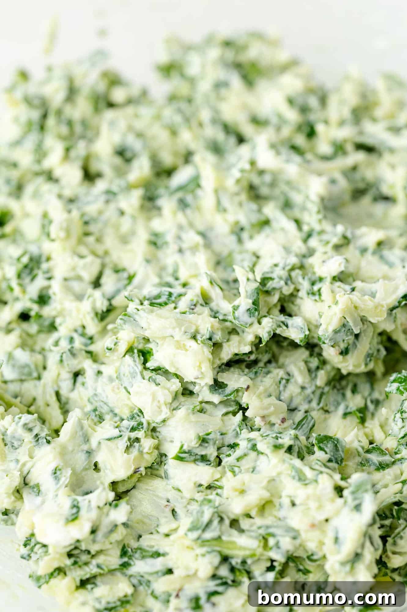 Creamy spinach and cheese stuffing prepared in a bowl.