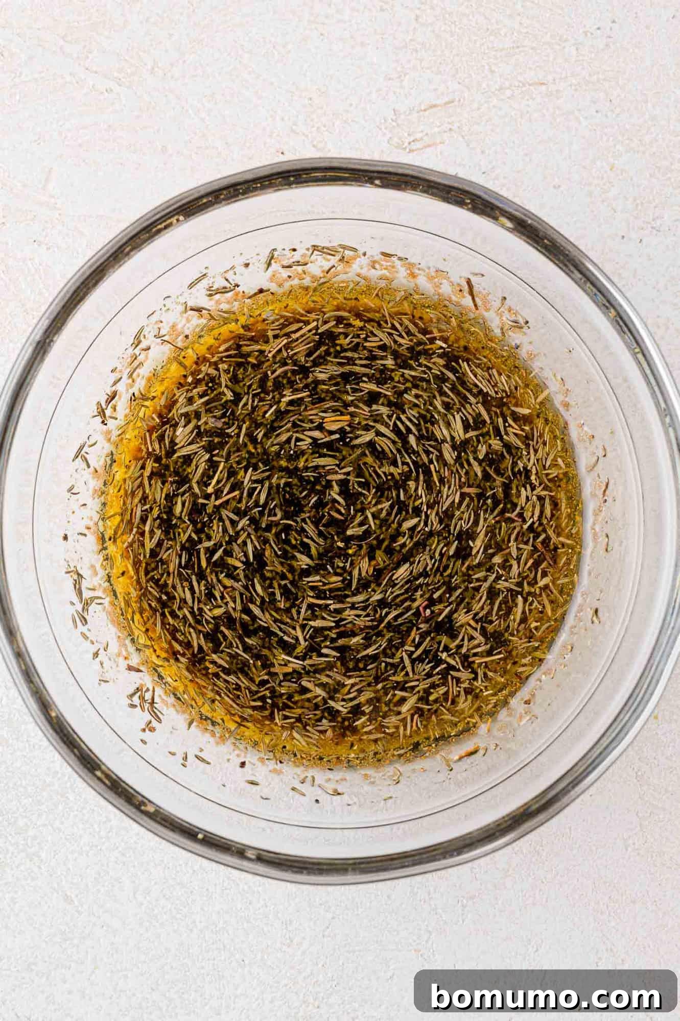 Marinade mixture in a small bowl with a whisk.