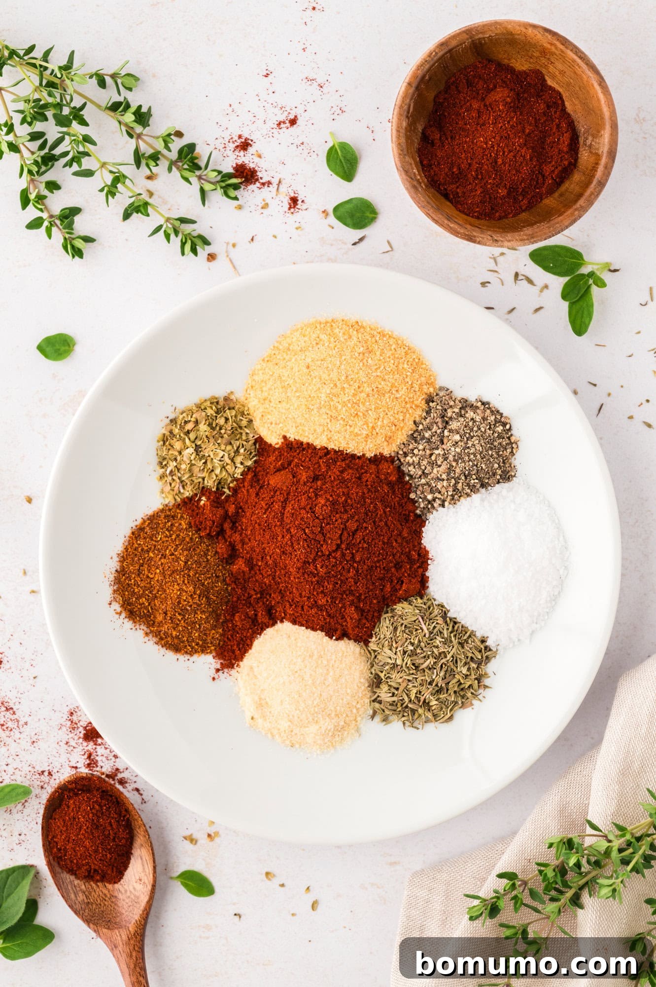 An array of unmixed spices for blackening seasoning, carefully arranged in a bowl, awaiting their flavorful combination.