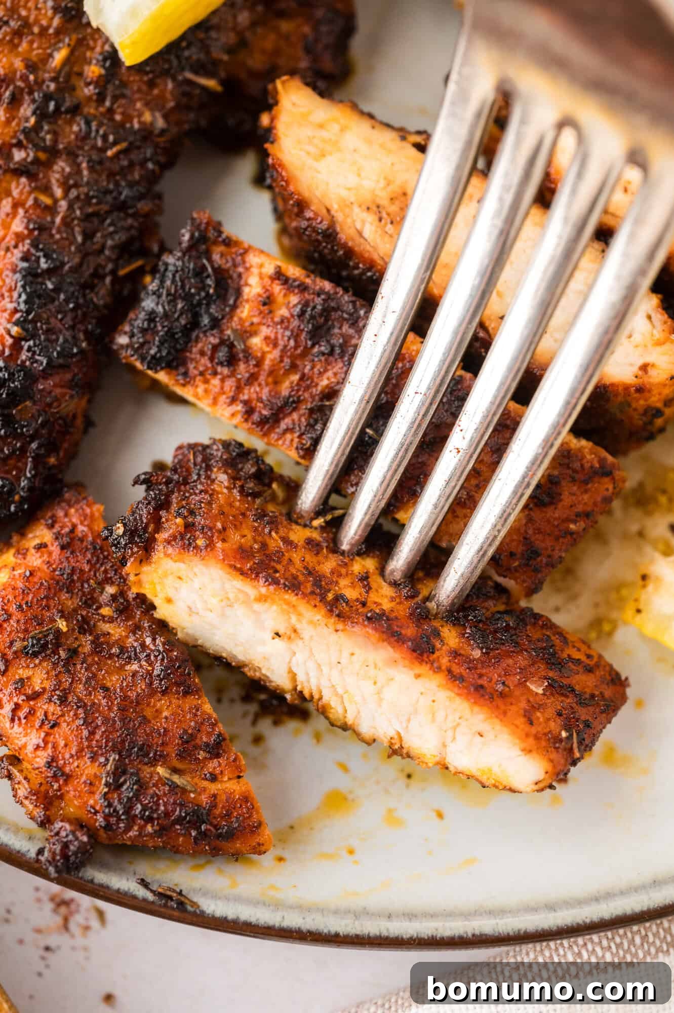 Perfectly seasoned chicken, coated with homemade blackening seasoning, ready for cooking to achieve a delightful crust.