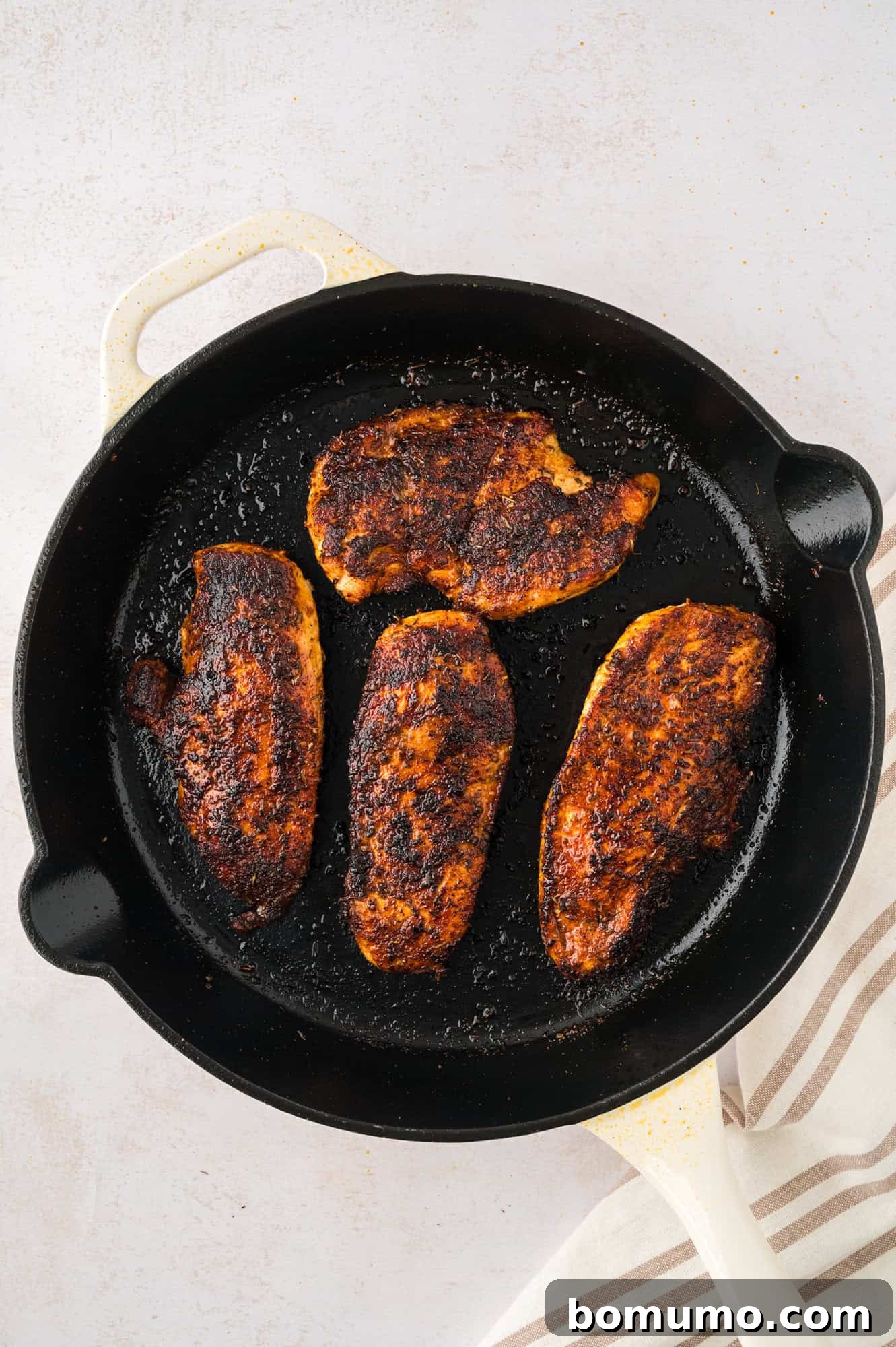 Blackened chicken in a cast iron pan.