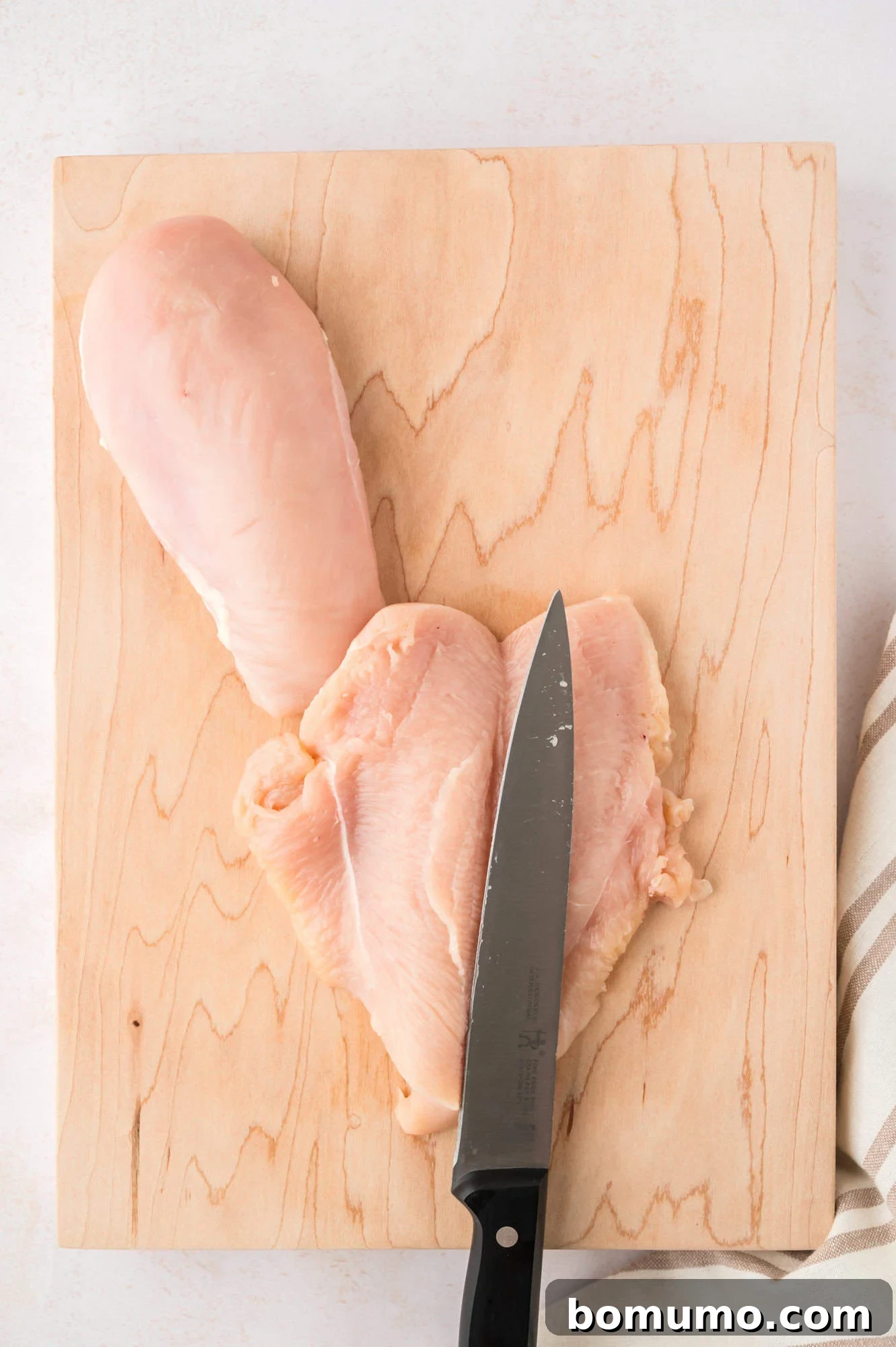 Chicken breast cut in half and opened like a butterfly.