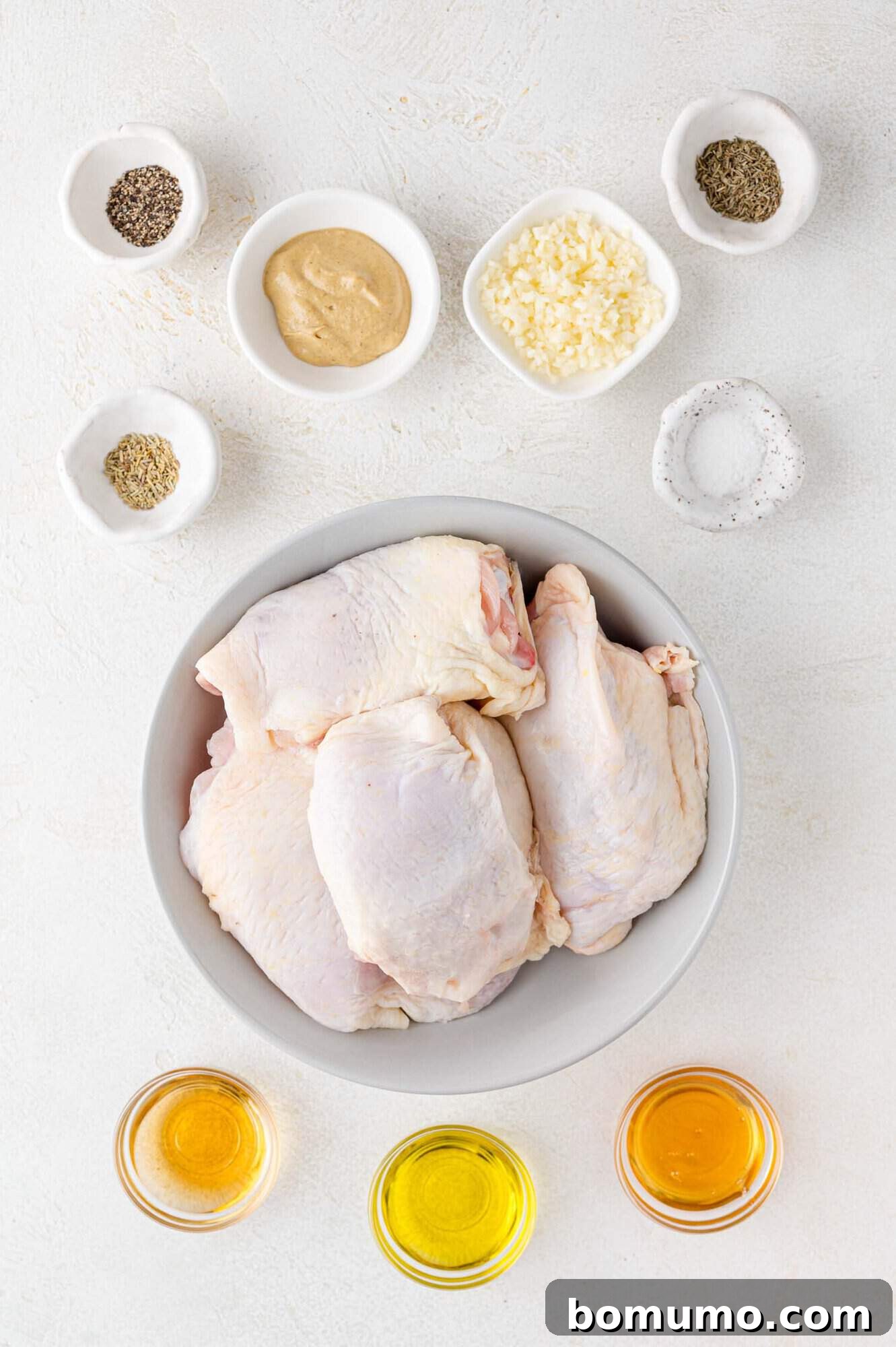 All the fresh and dried ingredients laid out for the grilled chicken thigh marinade recipe.