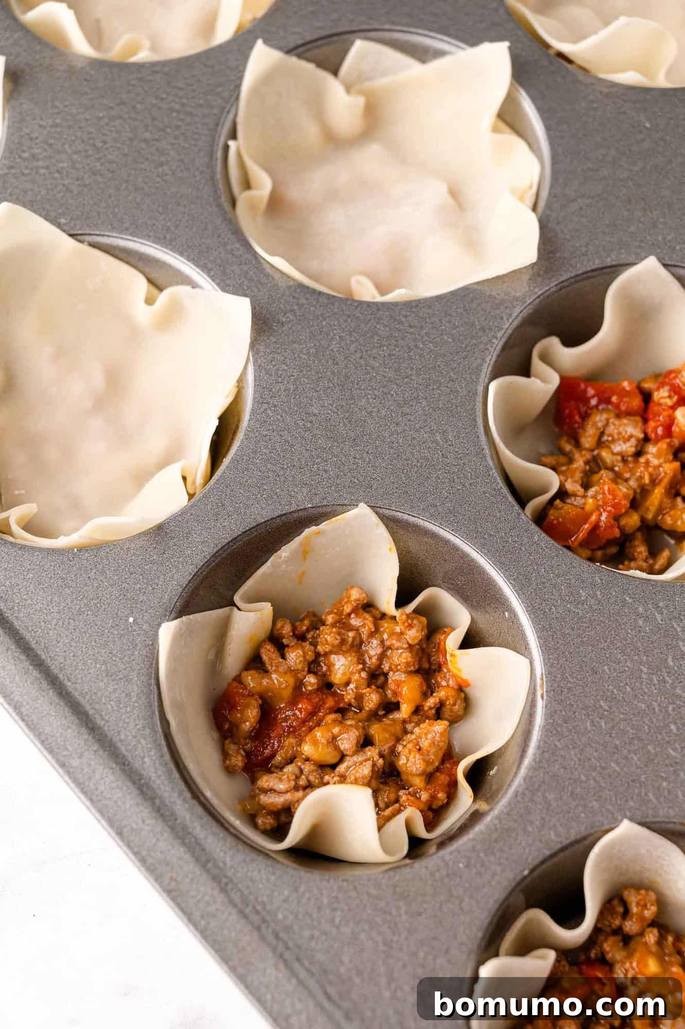 First layer of meat added to wonton.