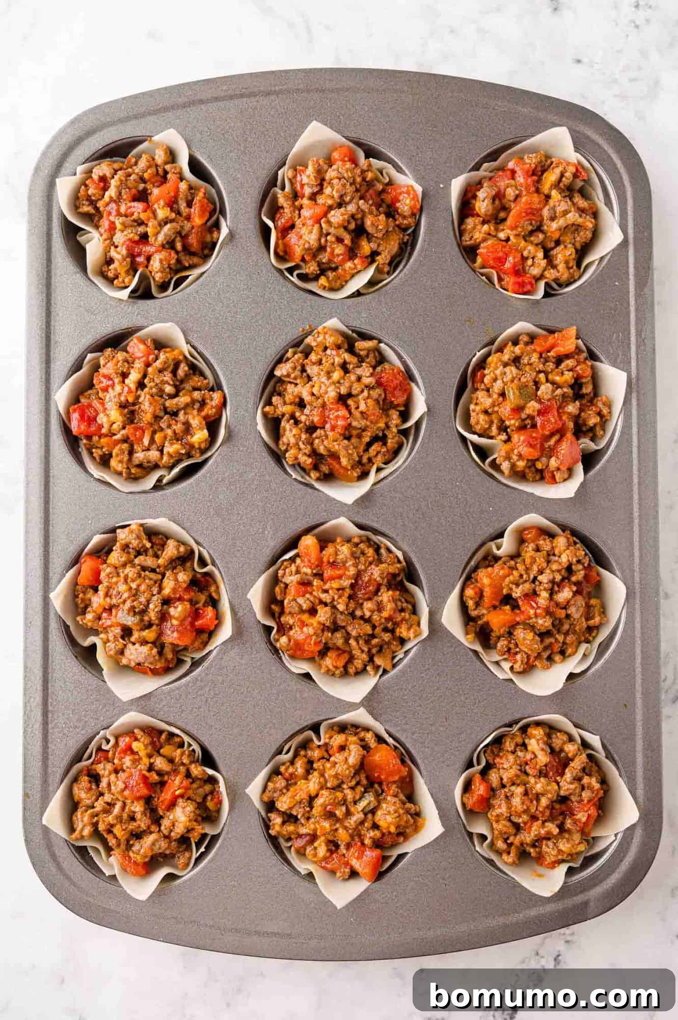 Remaining meat added to wonton cups.