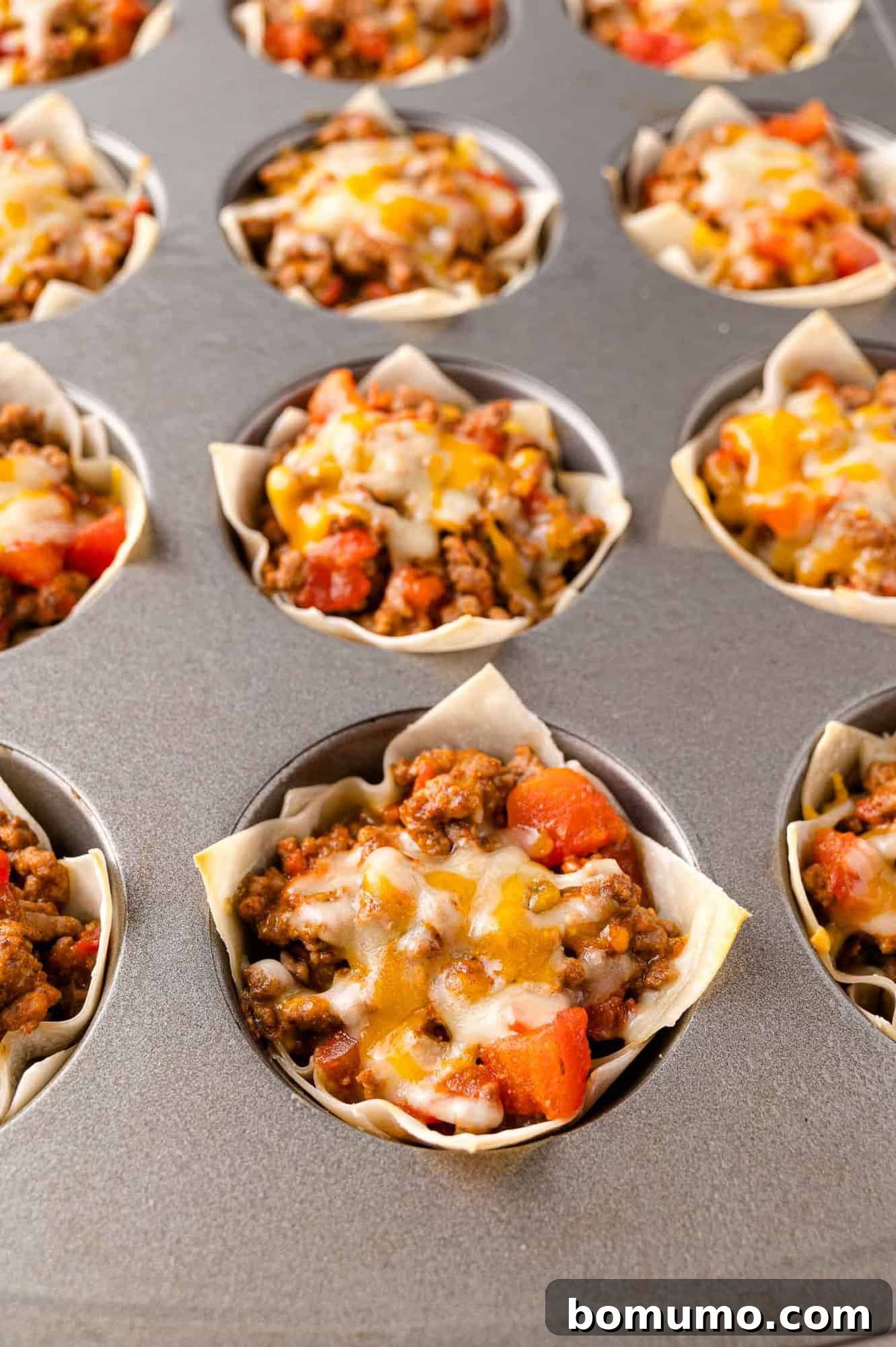 Cooked taco cups still in muffin tin.