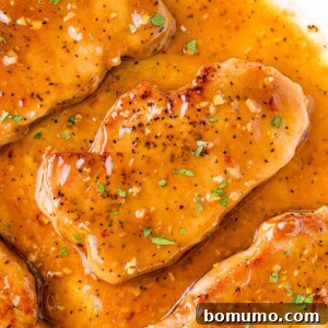 Honey garlic pork chops still in pan, ready to serve.