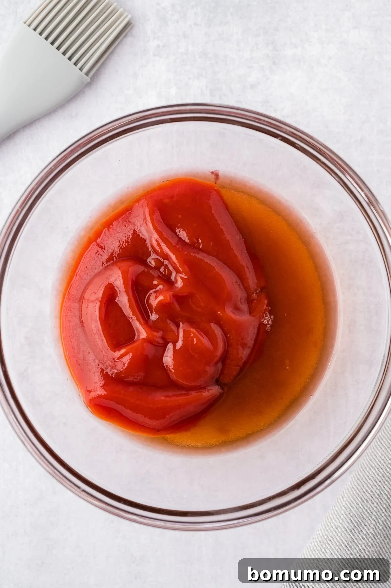 Individual ingredients for the meatloaf glaze – ketchup, brown sugar, and red wine vinegar – laid out separately.