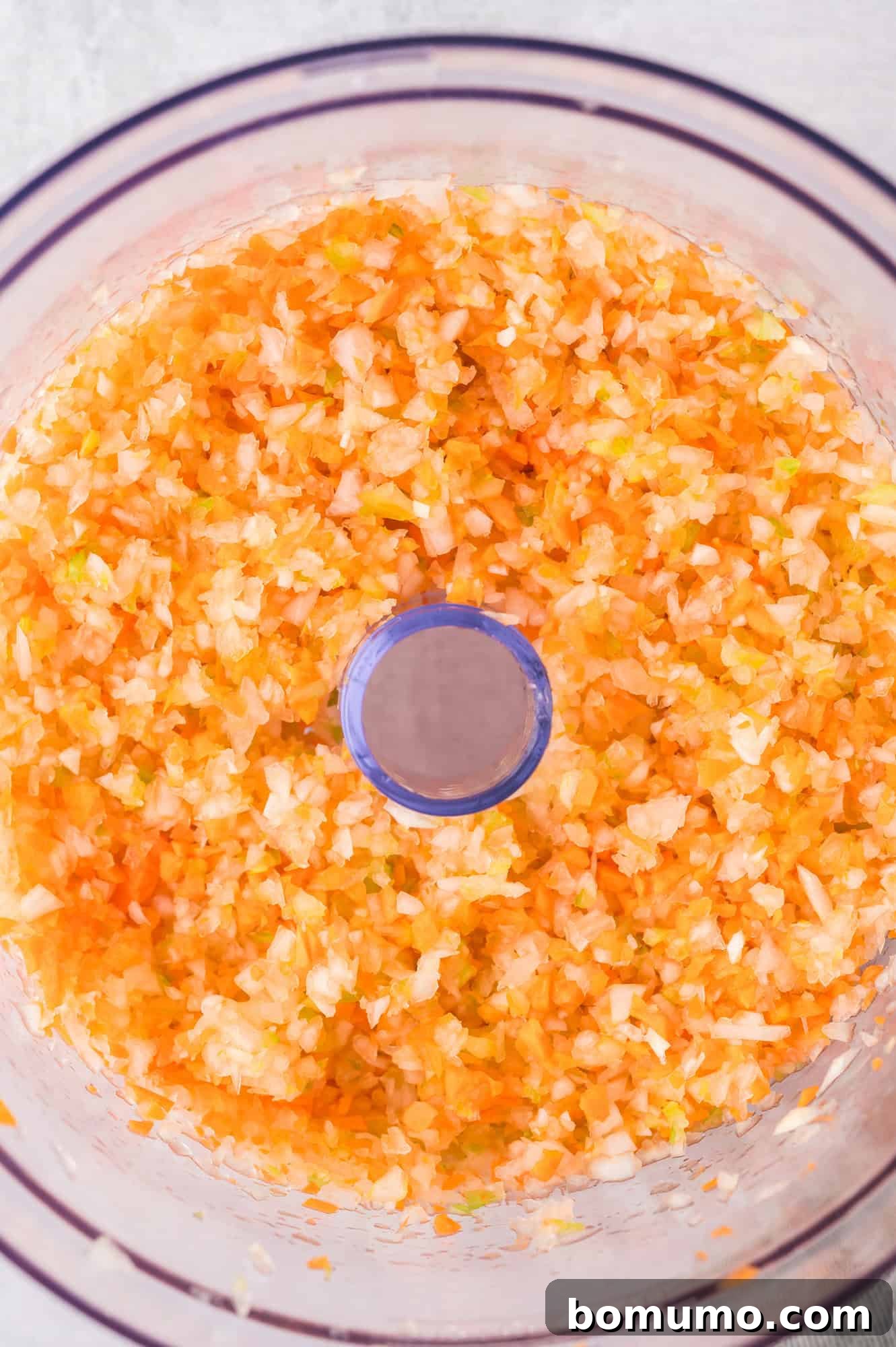 Finely pulsed vegetables in a food processor, a perfect consistency for meatloaf.