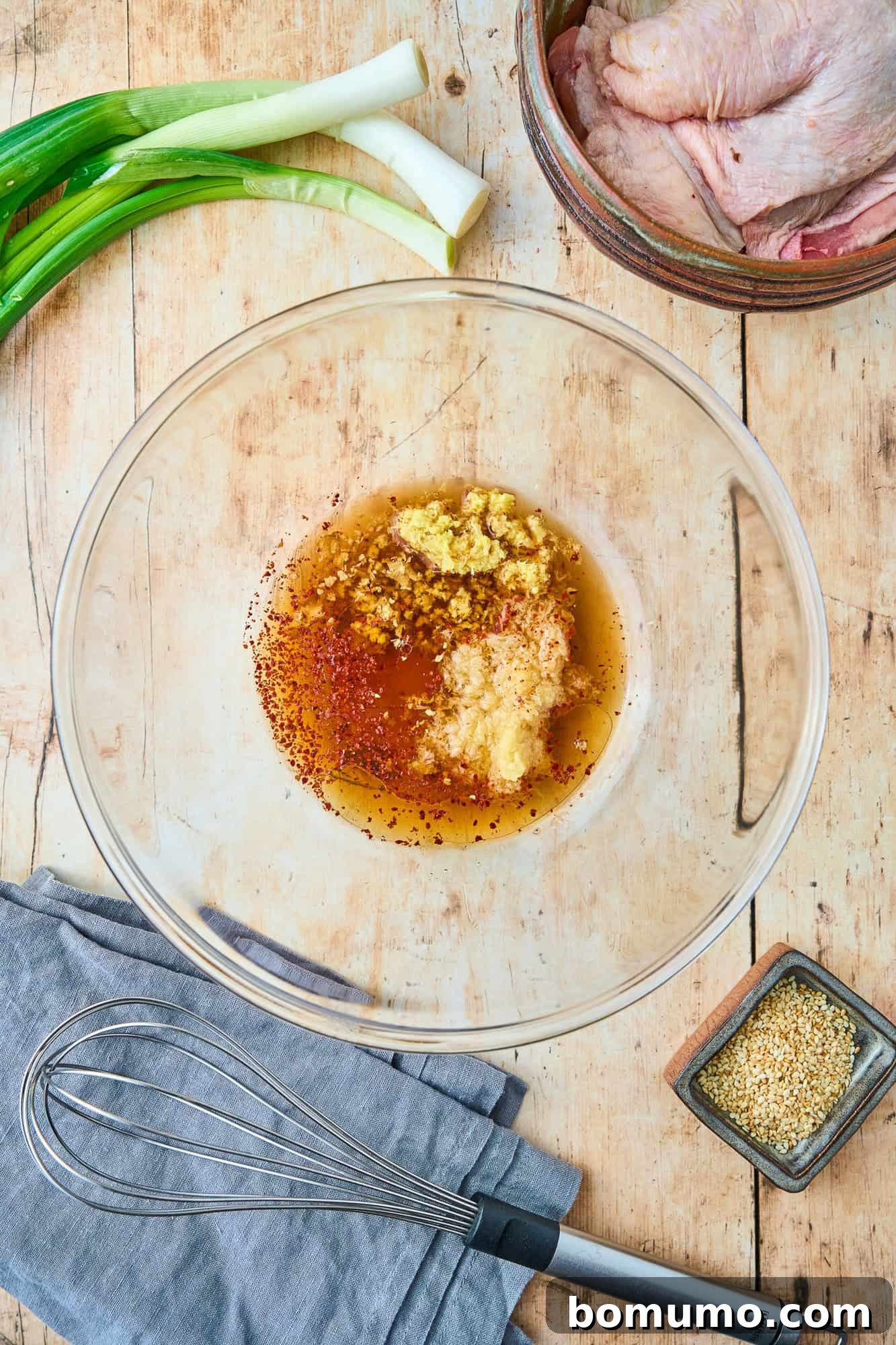 Individual ingredients for the marinade, including ginger, garlic, soy sauce, and honey, neatly arranged before mixing.