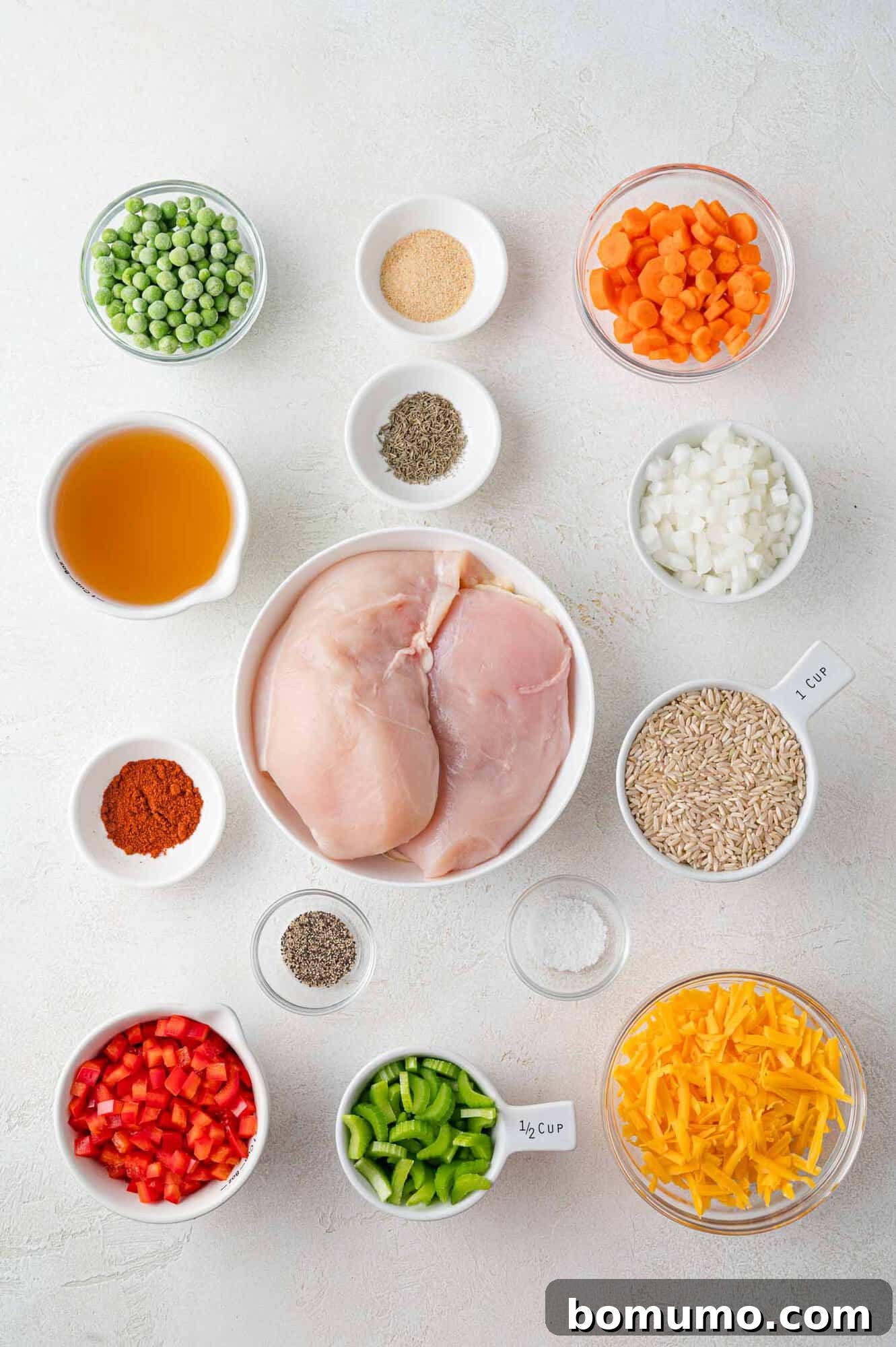 An overhead view displaying all the fresh, colorful ingredients laid out on a countertop, ready for the Crockpot chicken and rice recipe.