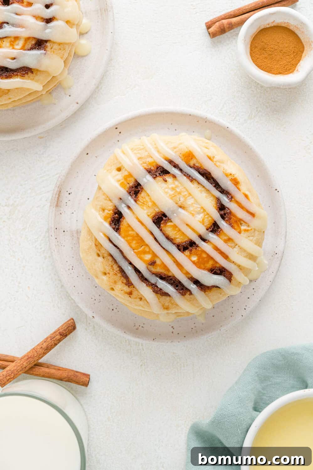 Cinnamon Swirl Flapjacks 11 Pancake with a cinnamon swirl, drizzled with powdered sugar icing.