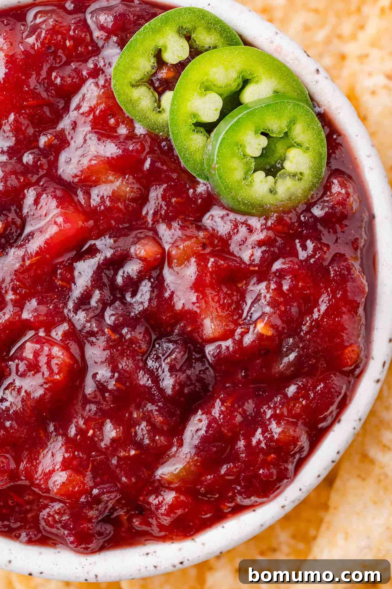 Simple Two Ingredient Cranberry Salsa 2 Overhead view of cranberry salsa, garnished with sliced jalapeño.