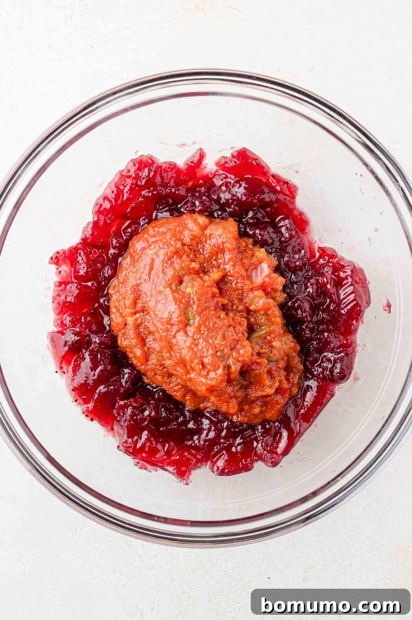 Simple Two Ingredient Cranberry Salsa 7 Cranberry sauce and salsa in a clear glass bowl, not yet mixed together.