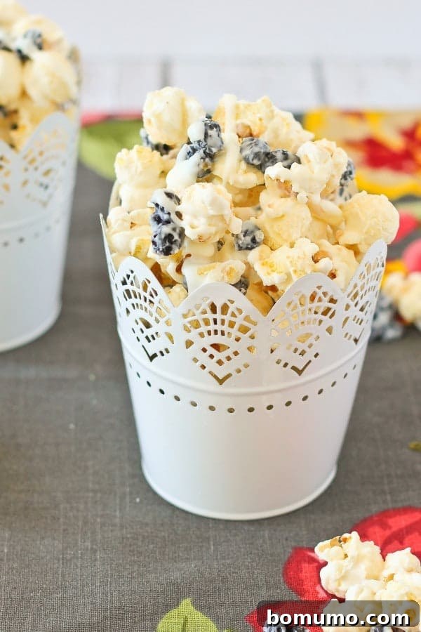 Blueberry Cream Pop 2 A serving of Blueberry and Cream Popcorn in a decorative cup.