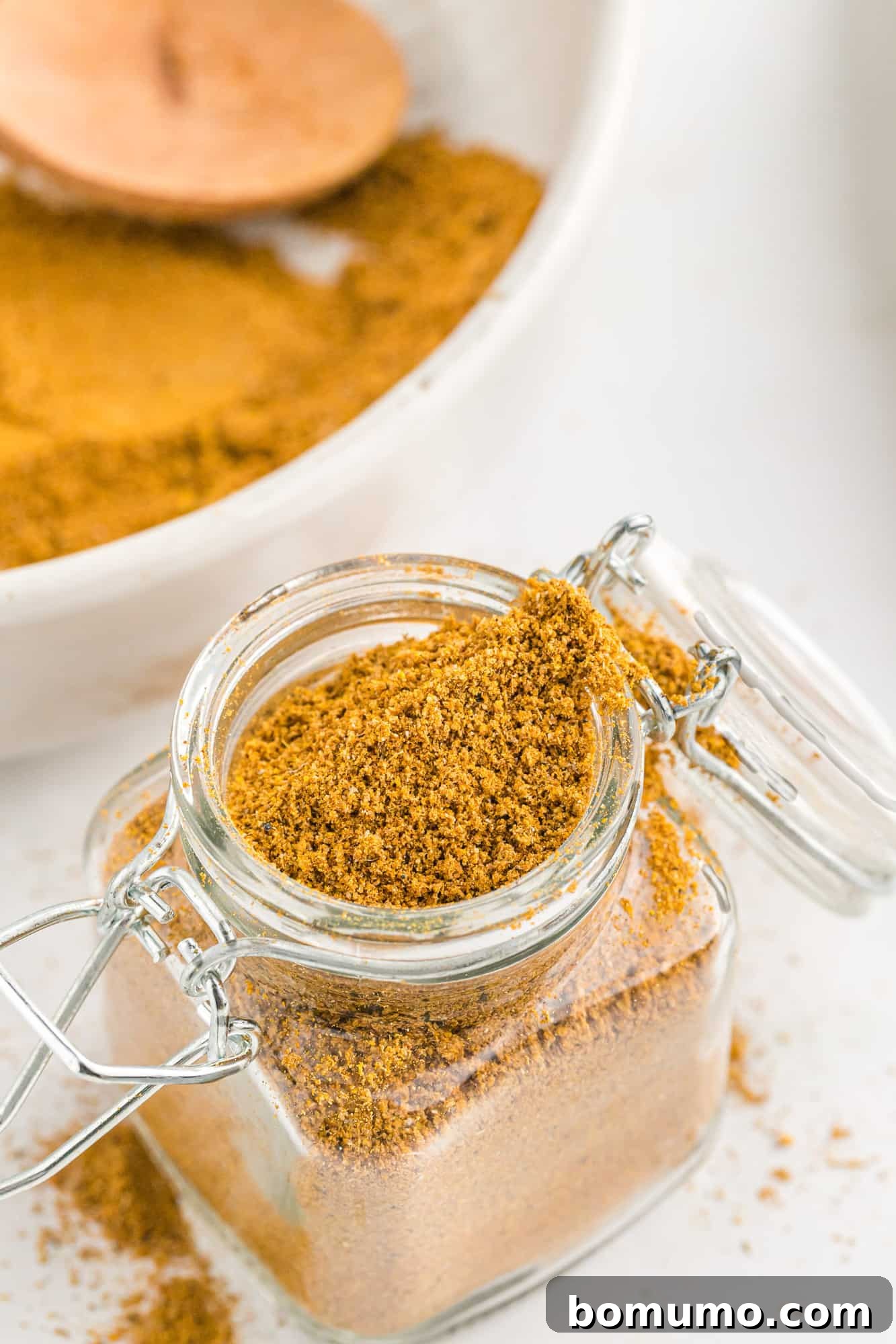Curry powder blend in a small glass jar, ready for storage.