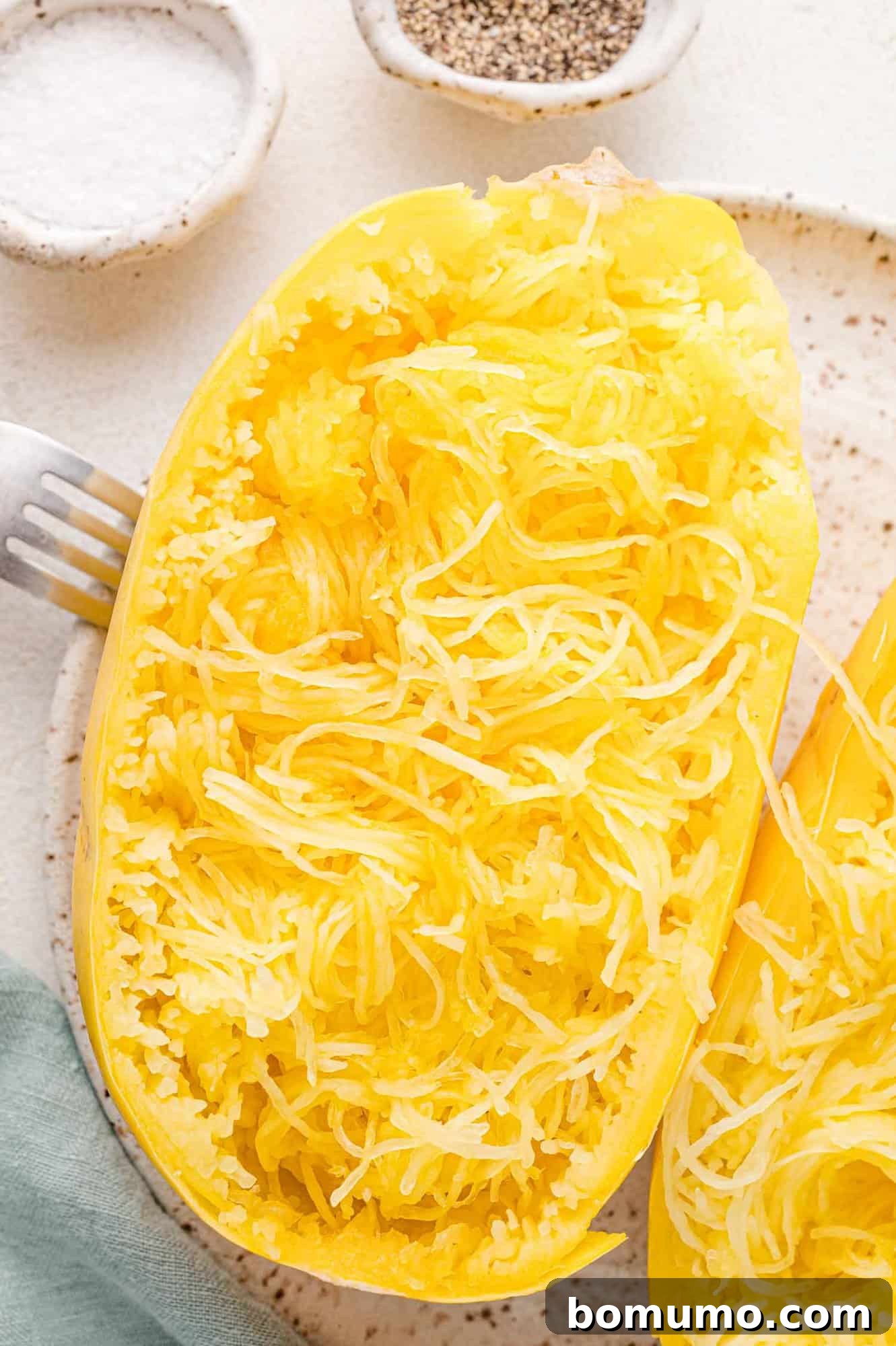 Easy Instant Pot Spaghetti Squash 2 Cooked spaghetti squash halves, cut stem to end, strands fluffed inside peel.