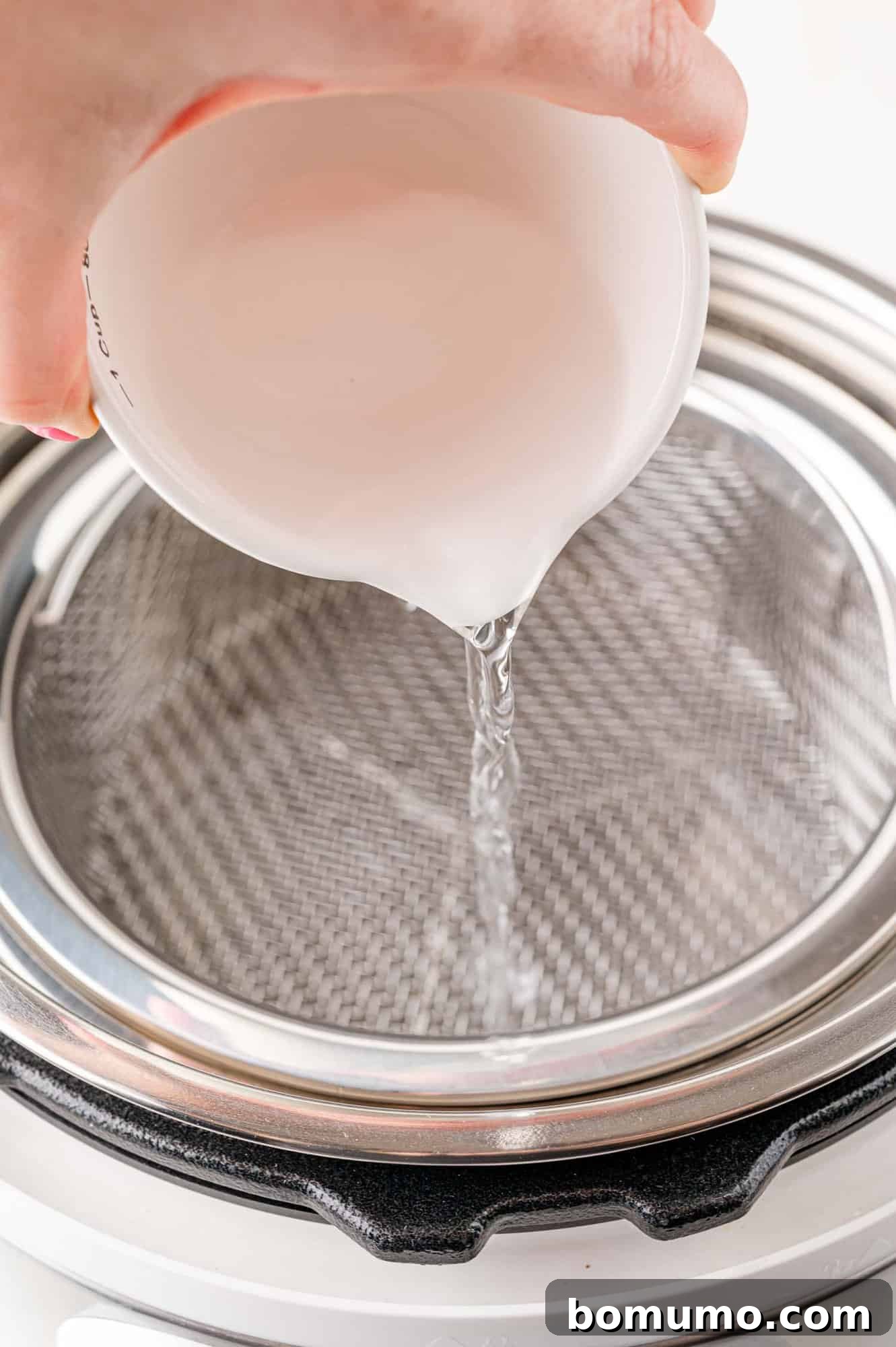 Easy Instant Pot Spaghetti Squash 6 Water being poured into an iInstant pot.