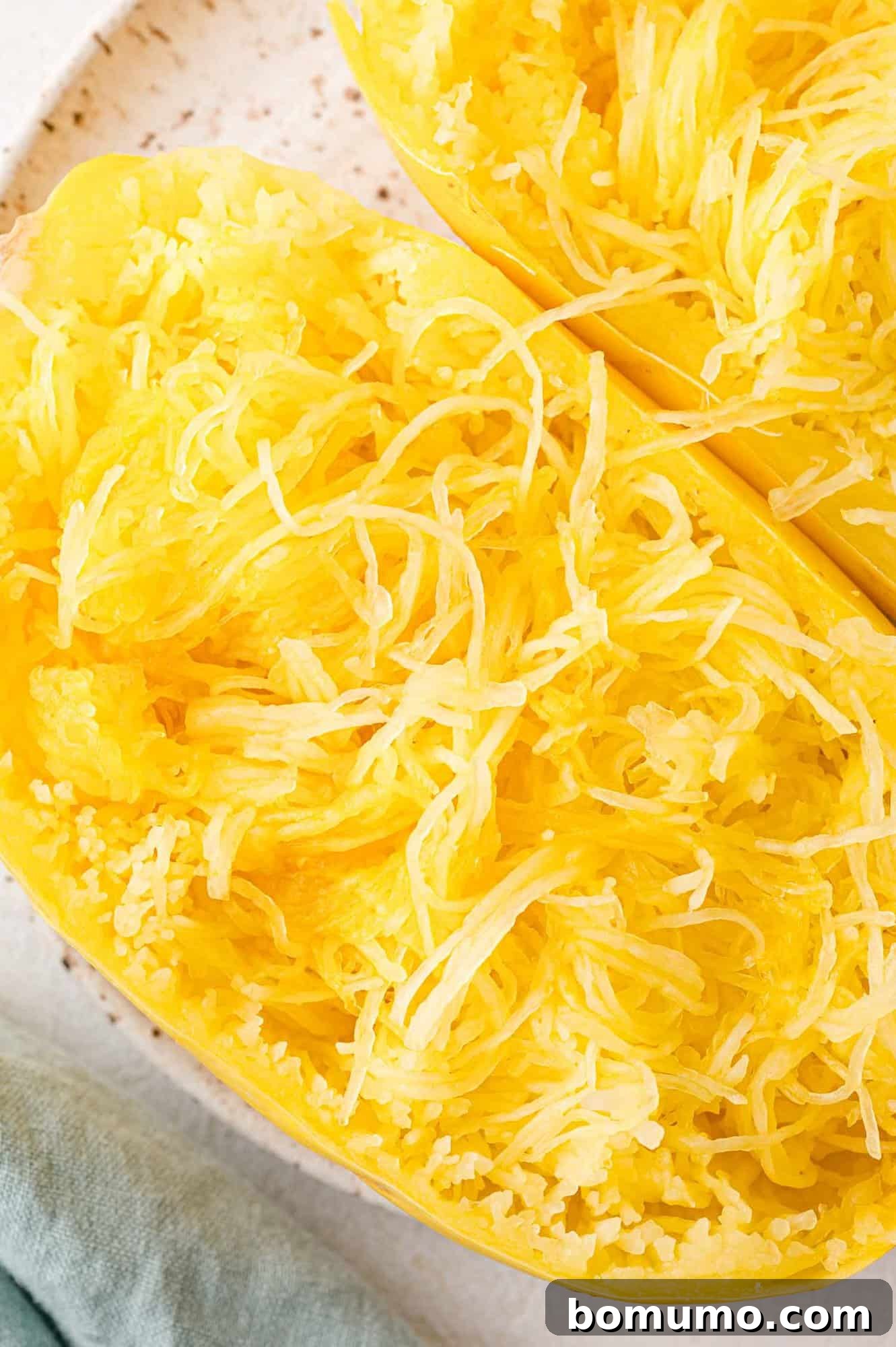Easy Instant Pot Spaghetti Squash 9 Strands of Instant Pot spaghetti squash fluffed and separated but still in squash half.