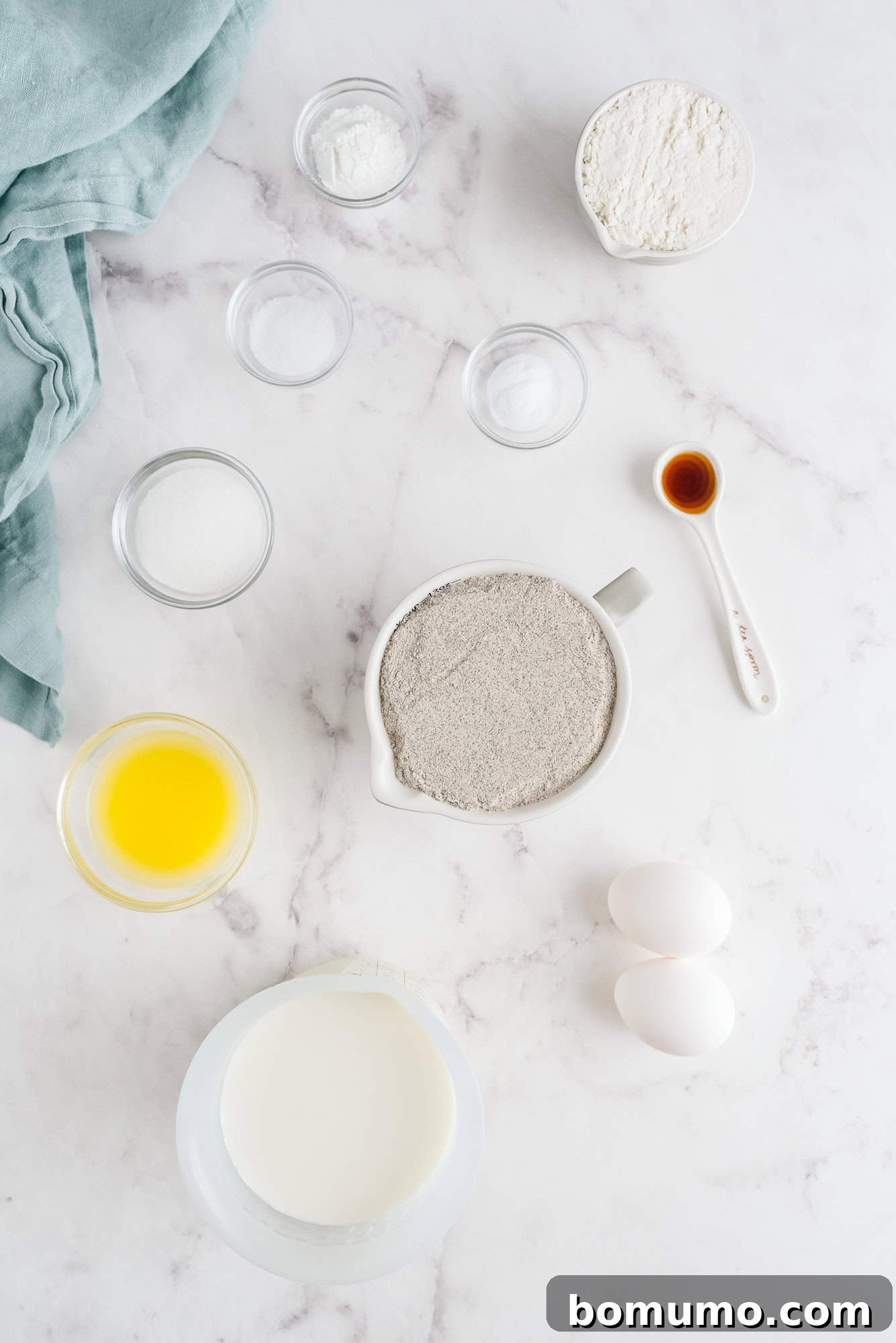An overhead view showcasing all the fresh and dry ingredients meticulously laid out for preparing delicious buckwheat pancakes.