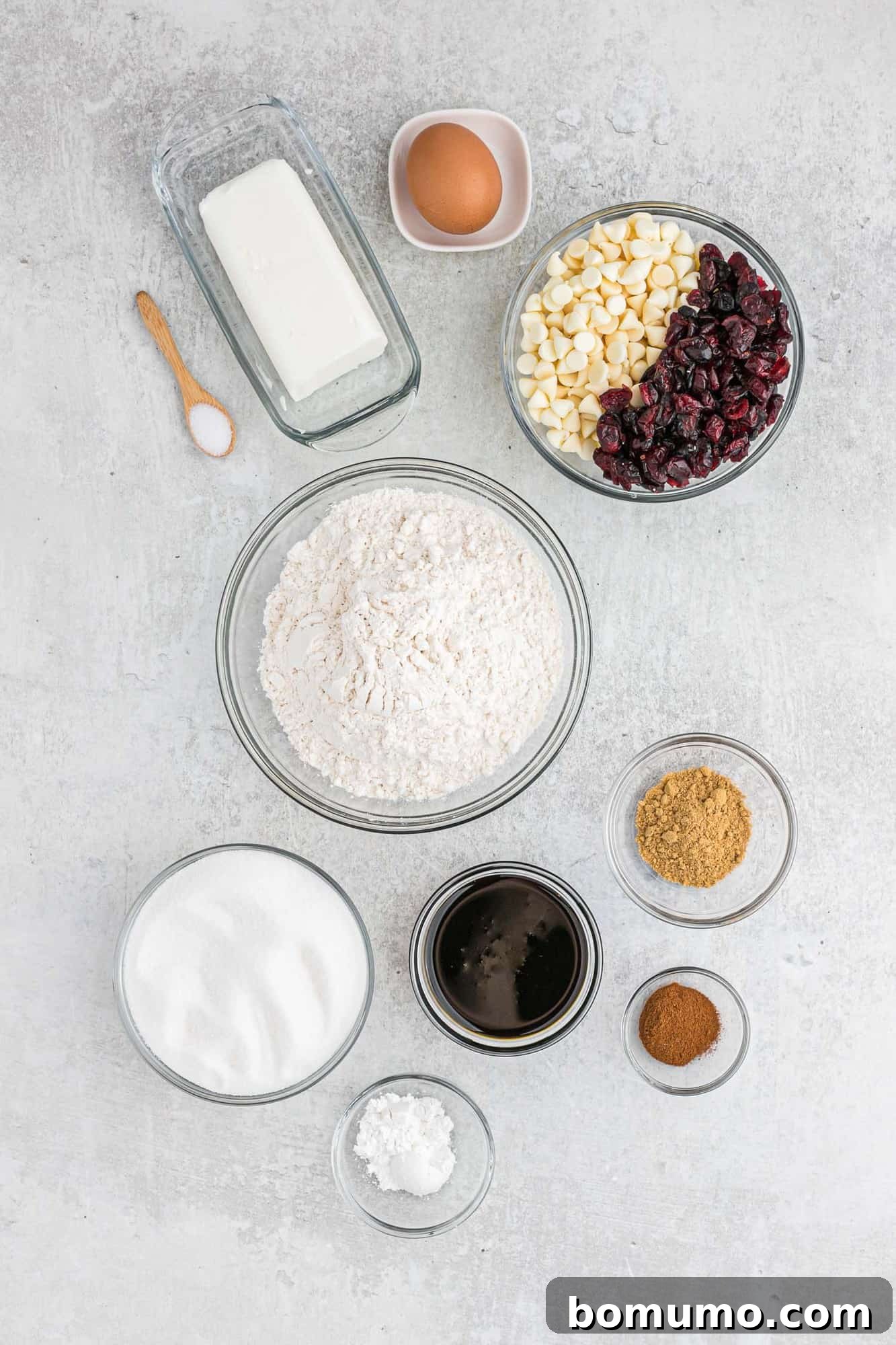 Overhead view of all ingredients needed for gingersnap cookies, neatly arranged on a counter to show the variety of spices, baking essentials, and delightful additions.