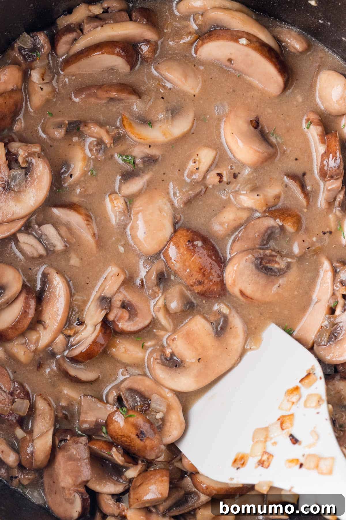 Mushrooms are being cooked a roux.