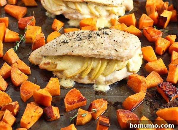 A close-up, front view of the roasted chicken and sweet potatoes, showing off their caramelized edges and inviting textures.