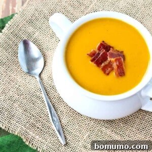 Warm and soothing, this butternut squash soup is easy to make and perfect year-round. You'll love the crispy bacon on top! Get the easy recipe on RachelCooks.com!